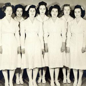 Nurses dressed in full uniform and hats circa 1928